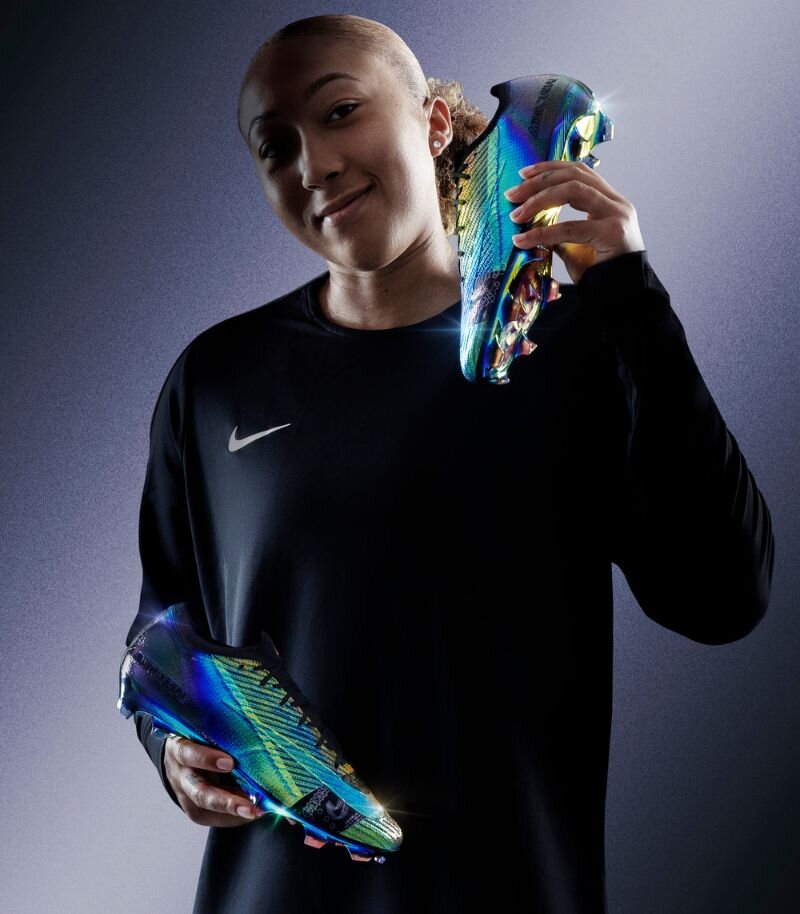 Footballer Lauren James holding Nike Mercurial Superfly boots in Cosmic Speed style